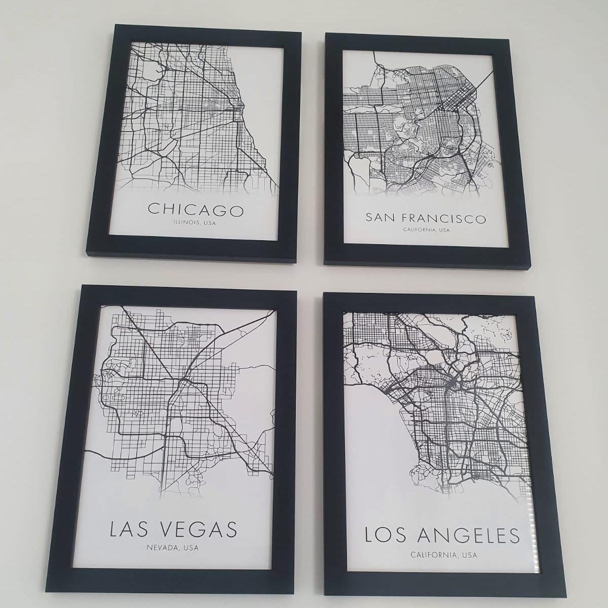 Four city map prints in matching black frames — Chicago, San Francisco, Las Vegas, Los Angeles